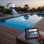Outdoor PTZ security camera with AI detecting abnormal movement around a private swimming pool at sunset, sending real-time “ABNORMAL MOTION DETECTED” alert to a tablet.