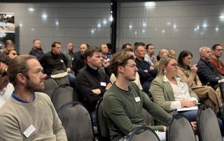 Close-up view of an attentive audience of professionals at a La Nuit des Piscines conference.