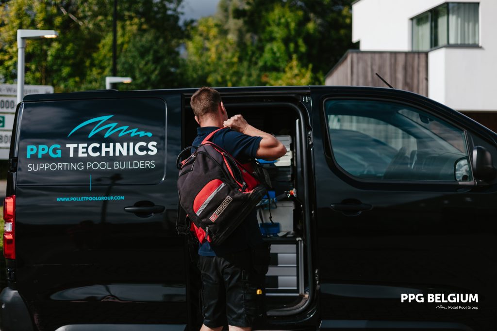 A PPG Technics technician getting tools out of a service van to support a pool builder on-site.