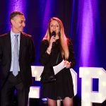 Mr. Figueroa presenting an award with a speaker at the 2026 Trophées de la Piscine et du Spa.