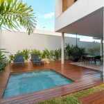 Modern smart mini pool integrated into a luxury wooden deck patio of a contemporary townhouse