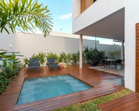 Modern smart mini pool integrated into a luxury wooden deck patio of a contemporary townhouse