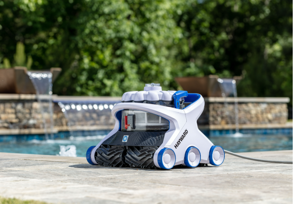 Hayward AquaVac 600 robotic pool cleaner on the edge of a modern swimming pool