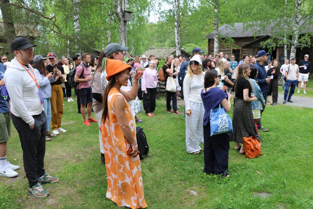Group of international wellness professionals networking outdoors at the World Sauna Forum.