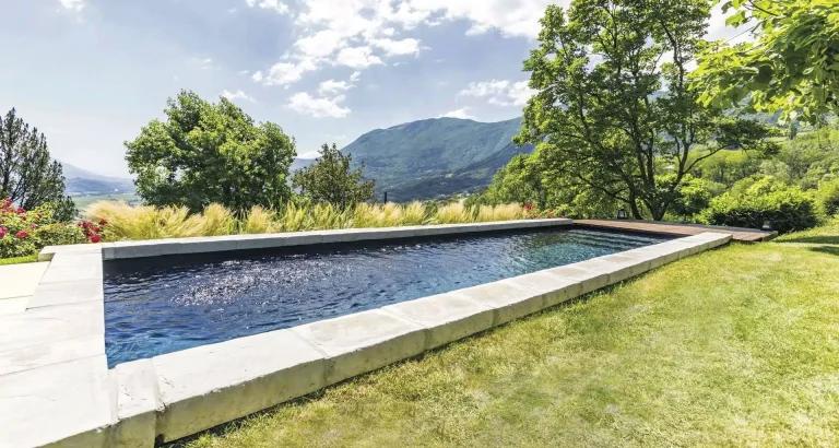 Residential backyard swimming pool during a summer drought period.