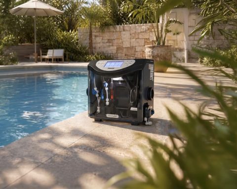 A Poolex Aqualyser automated water treatment and dosing unit placed horizontally on the stone edge of a sunny residential swimming pool.