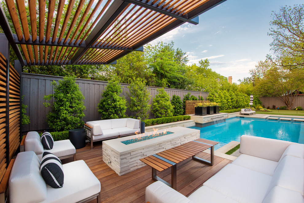 Luxury swimming pool surrounded by a beautifully landscaped outdoor living space.