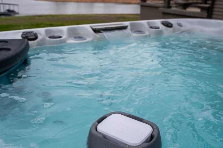 Purezone floating spa water monitor floating in outdoor hot tub water.