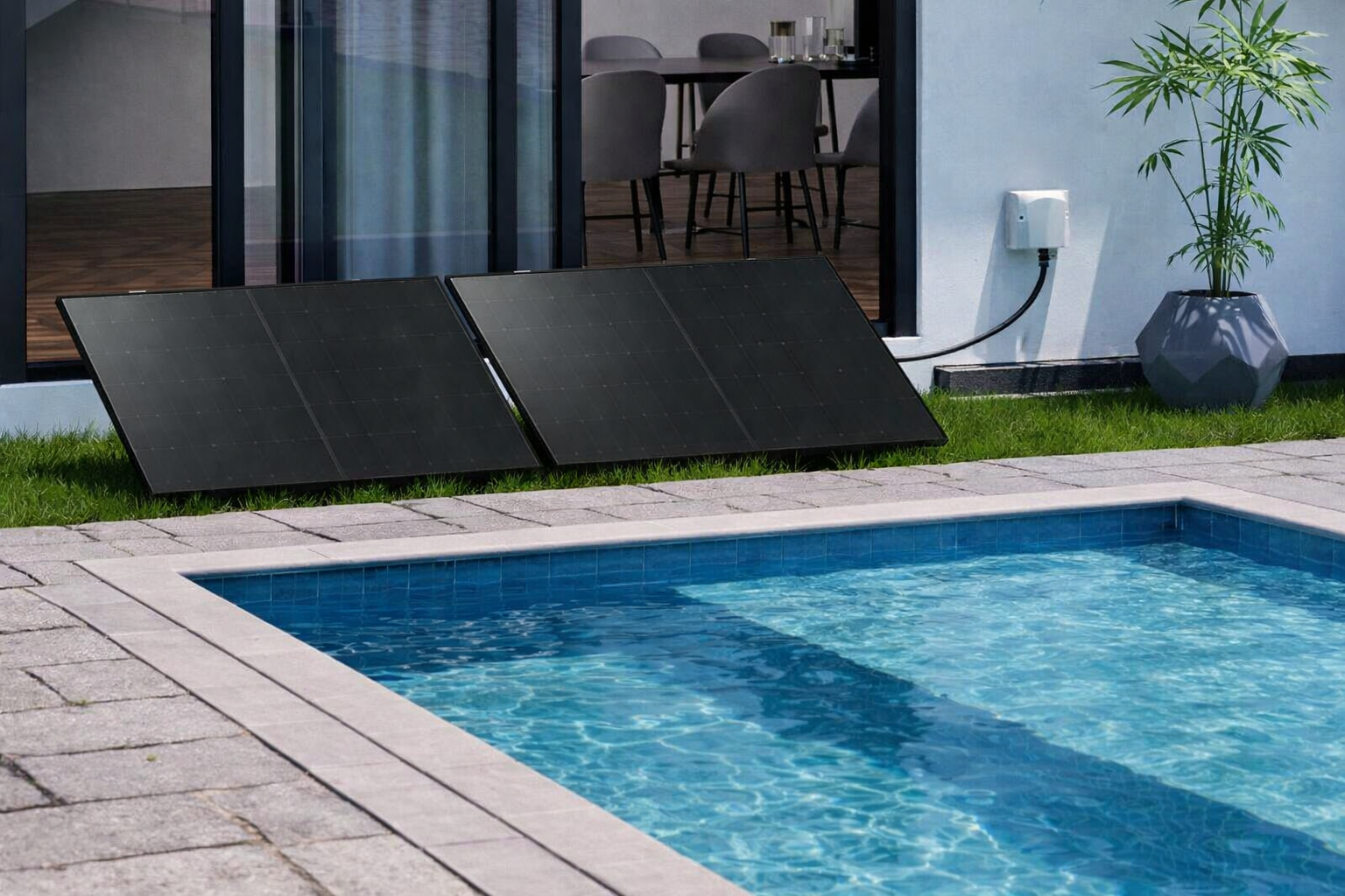Poolex Plug and Play solar kit with two photovoltaic panels installed on the lawn next to a swimming pool