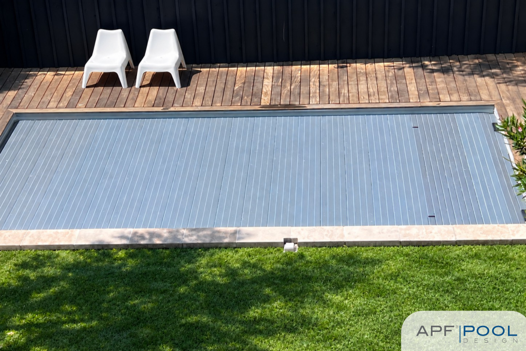 Top view of a swimming pool covered with the APF Pool Design DeckLine X320 slatted cover