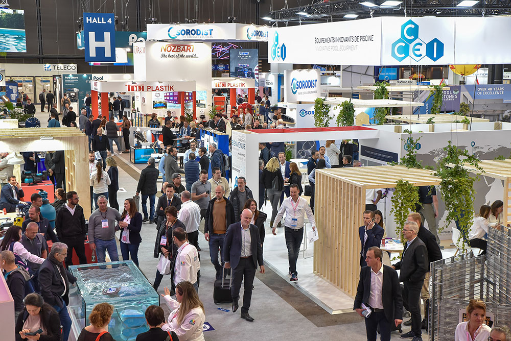 Crowded exhibition aisles at Piscine Global trade show in Eurexpo Lyon with pool equipment manufacturer stands