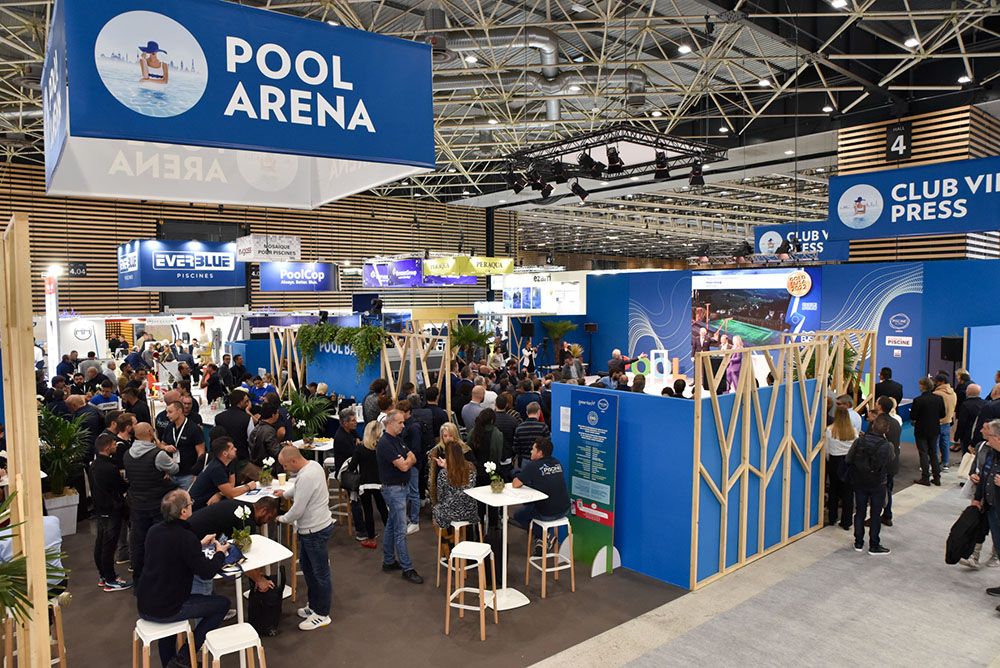 Attendees gathered in the Pool Arena lounge area surrounded by exhibitor booths at Piscine Global