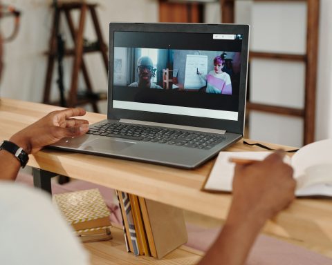 Professional attending an e-learning session on a laptop for pool trade remote training.