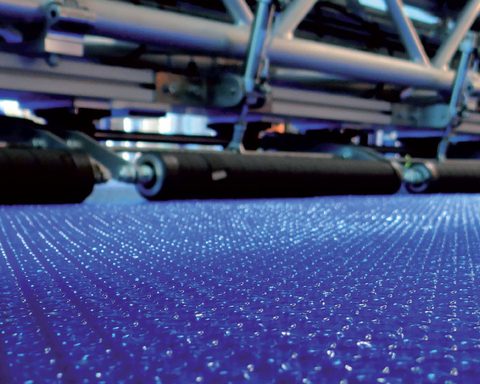 Manufacturing machinery processing blue OXO bubble film at the CID Plastiques plant in Valergues.