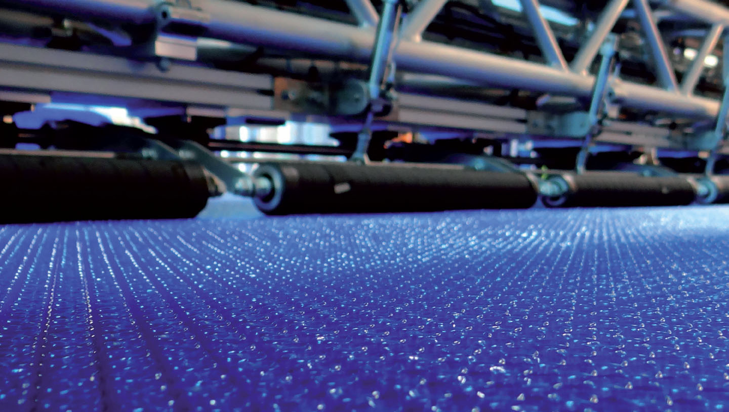 Manufacturing machinery processing blue OXO bubble film at the CID Plastiques plant in Valergues.