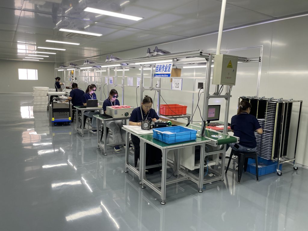 Technicians manually assembling electronic circuit boards for SEAMAID LED pool projectors